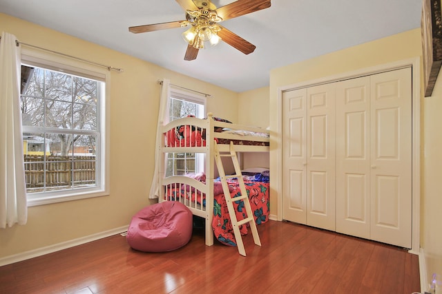 bedroom featuring hardwood / wood-style floors, a closet, and ceiling fan