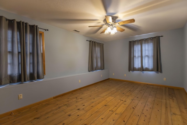 empty room with light wood-type flooring and ceiling fan