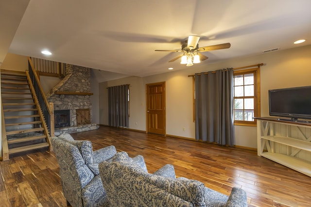 living room featuring a fireplace, hardwood / wood-style flooring, and ceiling fan