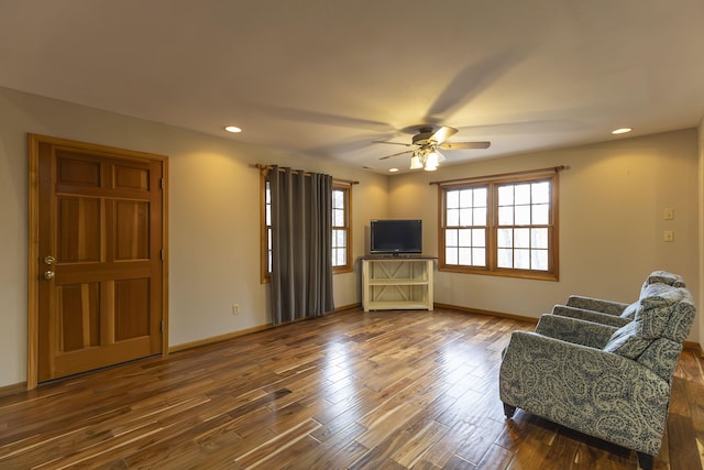 living room with hardwood / wood-style floors and ceiling fan