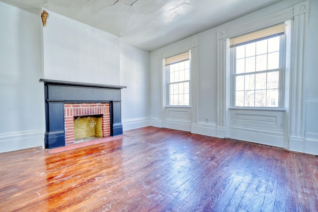 unfurnished living room with a fireplace and wood-type flooring