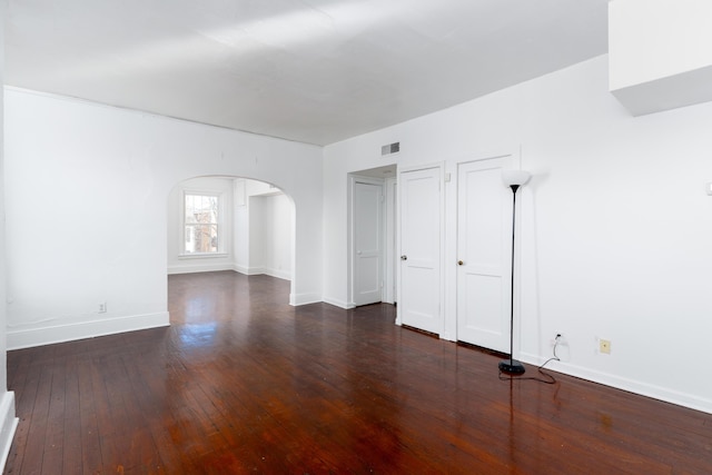 unfurnished room with dark hardwood / wood-style flooring