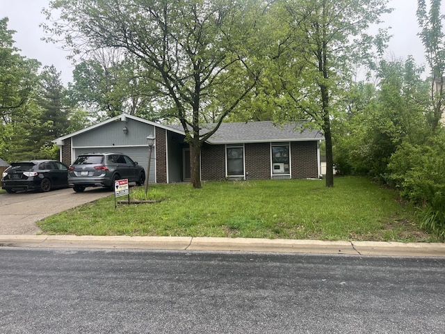 ranch-style house with a shingled roof, brick siding, a garage, a front yard, and driveway