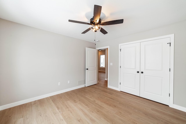 unfurnished bedroom with ceiling fan, a closet, and light hardwood / wood-style floors