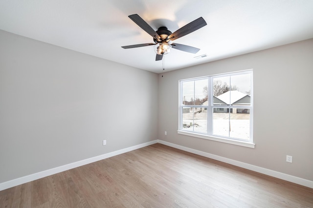 spare room featuring ceiling fan and light hardwood / wood-style floors