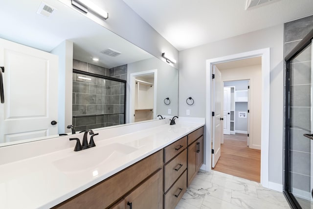 bathroom featuring vanity and an enclosed shower