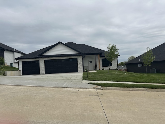 6031 Tamarack Dr, Columbia, MO 65203 - single story home featuring a garage, a front lawn, stone siding, and concrete driveway