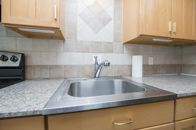 kitchen with sink, light brown cabinets, and decorative backsplash