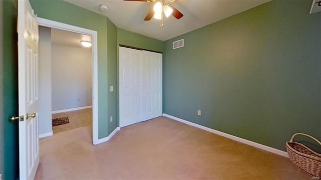 unfurnished bedroom with a closet, ceiling fan, and light colored carpet