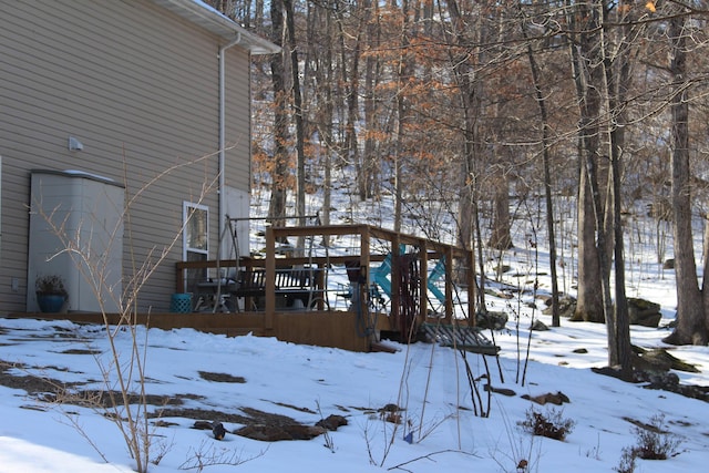 snowy yard with a deck