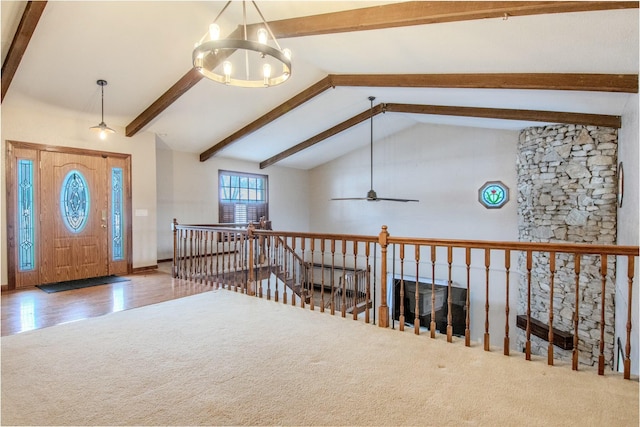 entrance foyer with lofted ceiling with beams, wood finished floors, and ceiling fan with notable chandelier