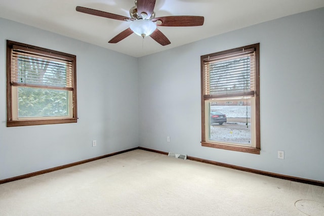 unfurnished room with baseboards, visible vents, ceiling fan, and carpet flooring