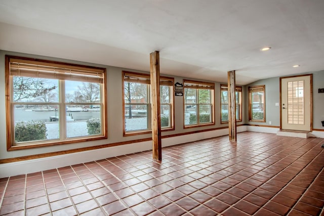 unfurnished room with recessed lighting, baseboards, vaulted ceiling, and tile patterned floors