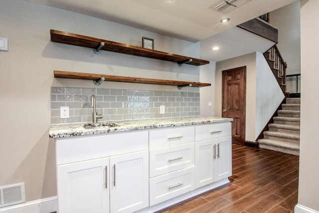 kitchen featuring open shelves, backsplash, dark wood finished floors, and visible vents