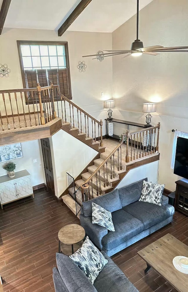 living room with vaulted ceiling with beams, wood finish floors, ceiling fan, and stairs