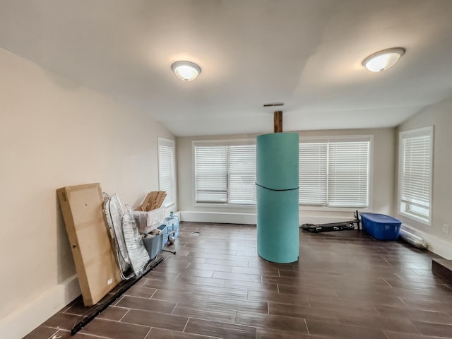 interior space featuring wood finish floors, visible vents, and baseboards