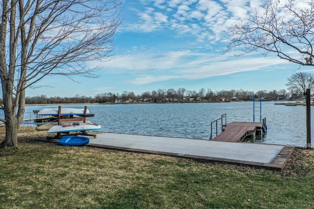 view of dock featuring a water view and a lawn