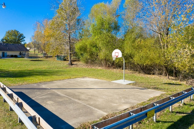 view of basketball court with community basketball court and a yard