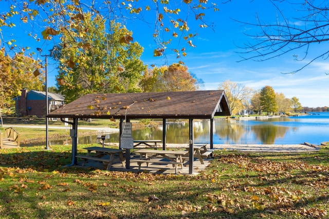 view of community featuring a water view and a yard