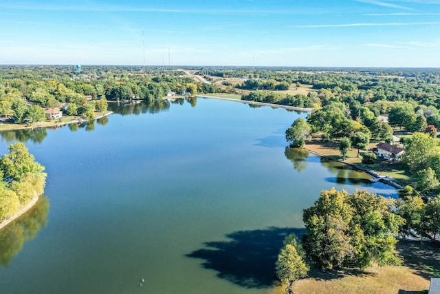 birds eye view of property featuring a water view and a view of trees