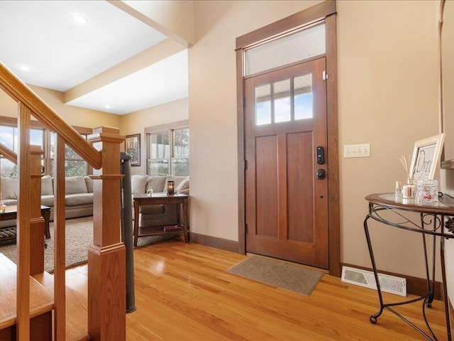 foyer entrance with recessed lighting, visible vents, baseboards, stairway, and light wood-type flooring