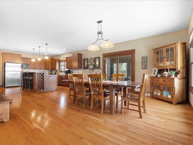 dining space featuring light wood-style floors and recessed lighting