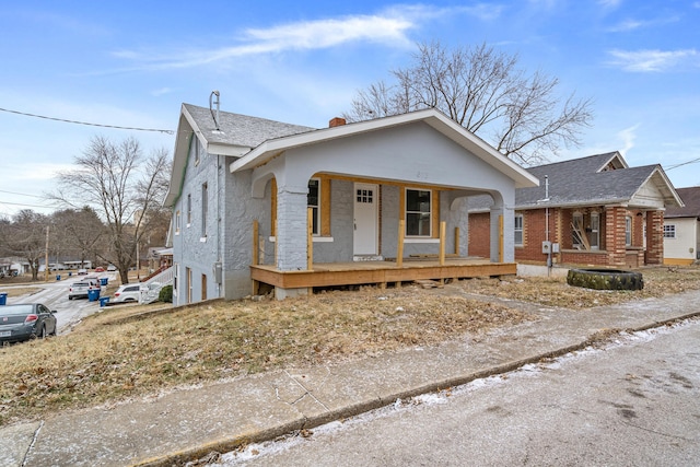 bungalow featuring a porch and a shingled roof