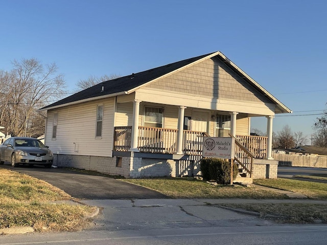 view of front of home with driveway and a porch