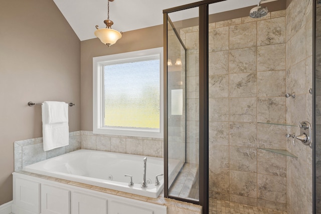 full bathroom with a whirlpool tub, vaulted ceiling, and a shower stall