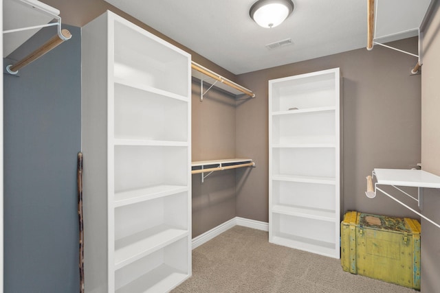 walk in closet featuring carpet floors and visible vents