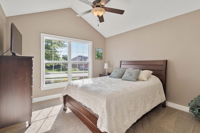 bedroom featuring carpet, vaulted ceiling, baseboards, and ceiling fan