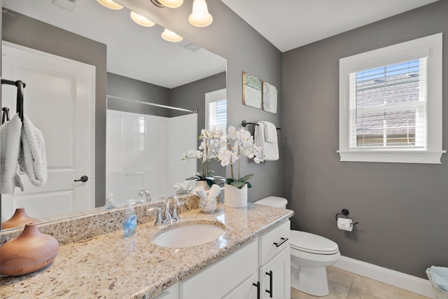 full bathroom with tile patterned flooring, toilet, vanity, baseboards, and walk in shower