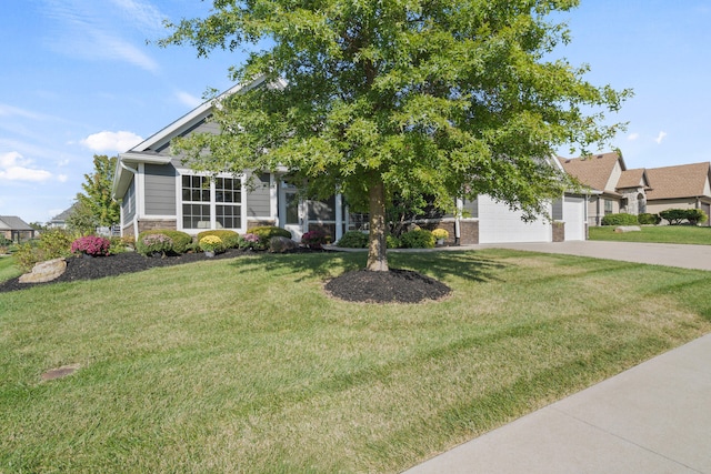 obstructed view of property featuring driveway, stone siding, a garage, and a front lawn