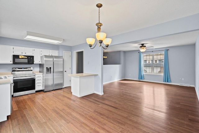 kitchen featuring white cabinets, light wood-style floors, appliances with stainless steel finishes, and light countertops