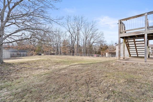 view of yard with stairway, fence, and a wooden deck