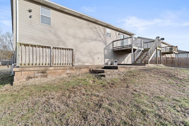 back of house with fence, stairway, and a wooden deck