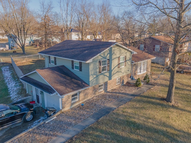 exterior space with a yard, a shingled roof, and fence