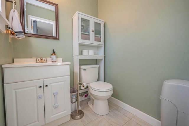 bathroom with vanity, tile patterned floors, toilet, and baseboards