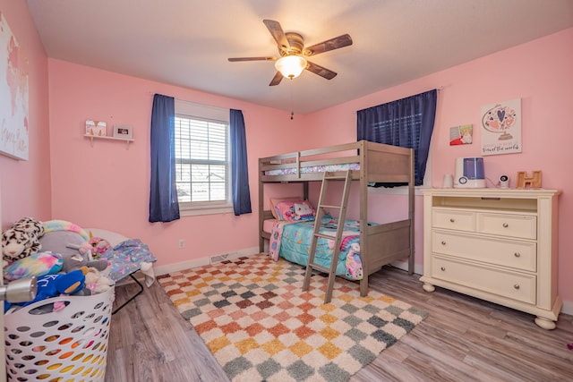 bedroom featuring a ceiling fan, wood finished floors, and baseboards