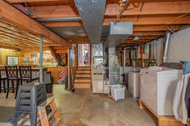 unfinished basement with gas water heater and independent washer and dryer