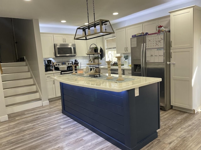 kitchen with light wood-type flooring, a center island, recessed lighting, stainless steel appliances, and decorative backsplash