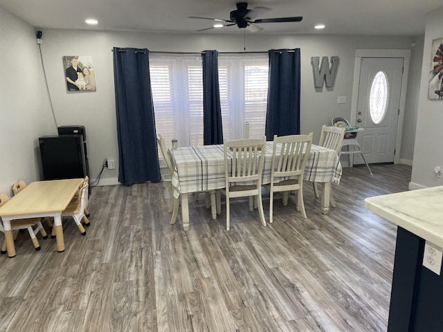 dining area with light wood finished floors, baseboards, and a wealth of natural light