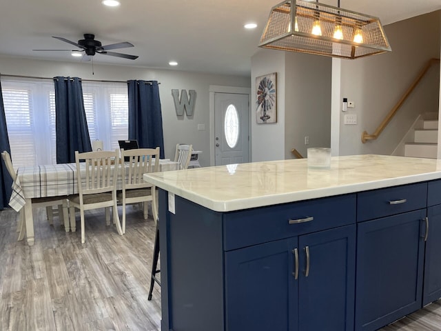 kitchen with recessed lighting, blue cabinetry, light wood-style flooring, and ceiling fan