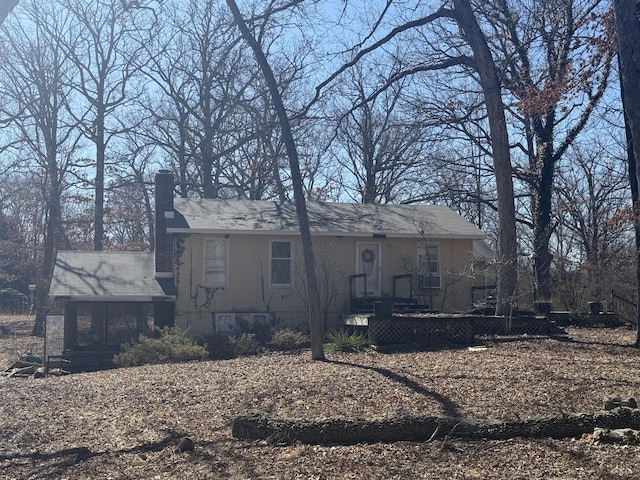 view of front facade with a chimney