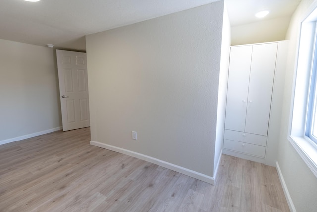 interior space with light wood-style flooring and baseboards