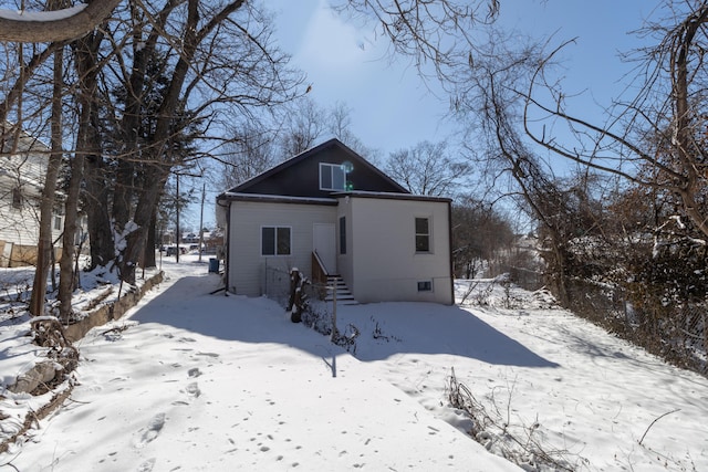 view of snow covered back of property