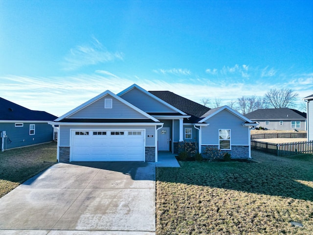 view of front of property with a garage, fence, stone siding, driveway, and a front lawn