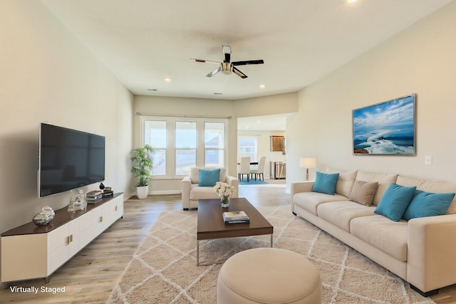 living area featuring light wood finished floors, baseboards, a ceiling fan, and recessed lighting