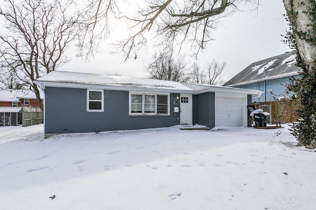 ranch-style home featuring fence and an attached garage