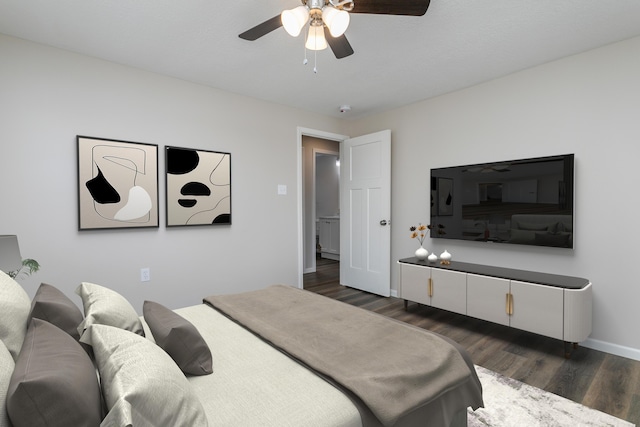 bedroom with a ceiling fan, dark wood-style flooring, and baseboards